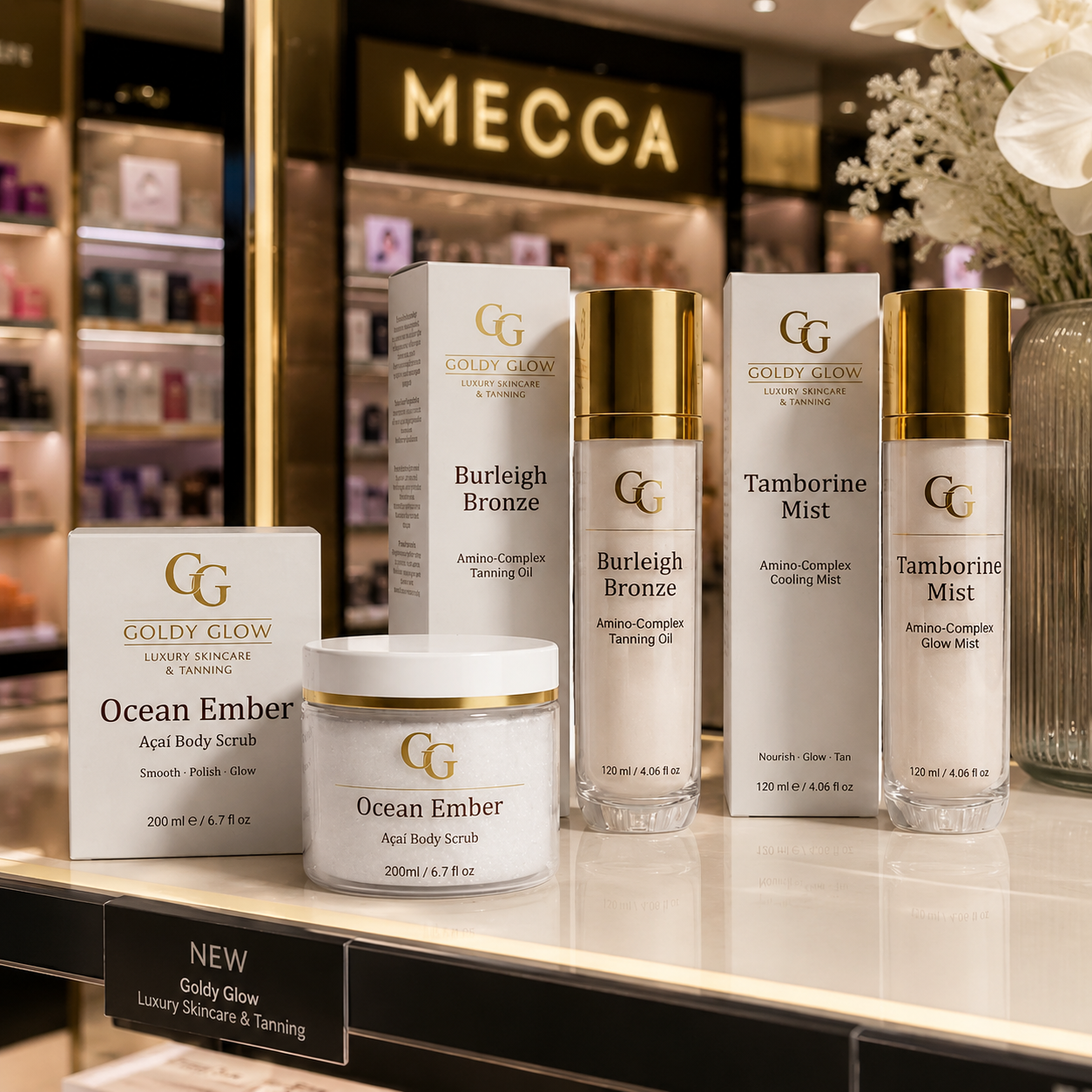 Goldy Glow peptide skincare collection displayed on a premium retail shelf, featuring Ocean Ember Body Scrub, Burleigh Bronze Peptide Tanning Oil and Tamborine Mist.