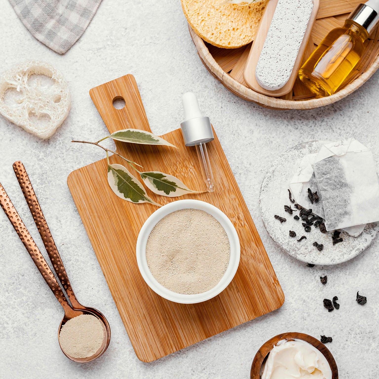 Simple tanning skincare routine laid out on neutral background